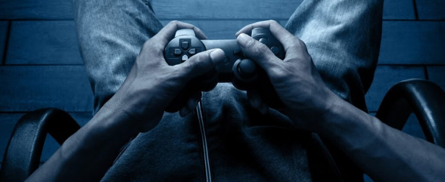 Man clutching Playstation controller