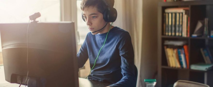 Teenage boy engrossed in computer gaming session