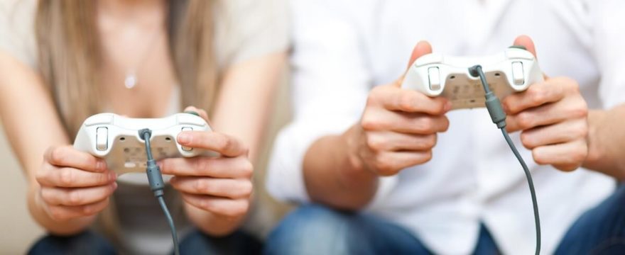 Young couple playing Xbox games