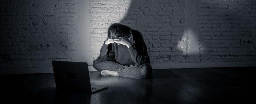 Distressed young girl sitting in front of laptop
