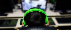 Young man with headphones engrossed in gaming