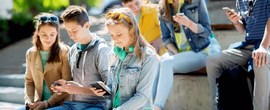 Young people using smartphones together